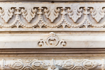 Ornament on the white granite wall of the temple in Vrndavana