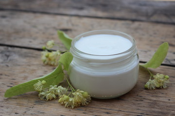 Fototapeta na wymiar Cosmetic cream with linden flowers