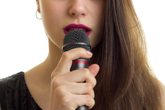 Close Up Of Woman With Red Lips Hold A Microphone At Her Mouth