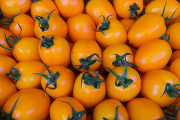 Fresh yellow small tomatoes in a box.