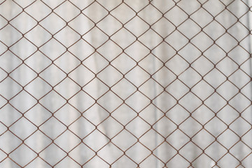 Texture of an old rusty mesh. Metal net on white background