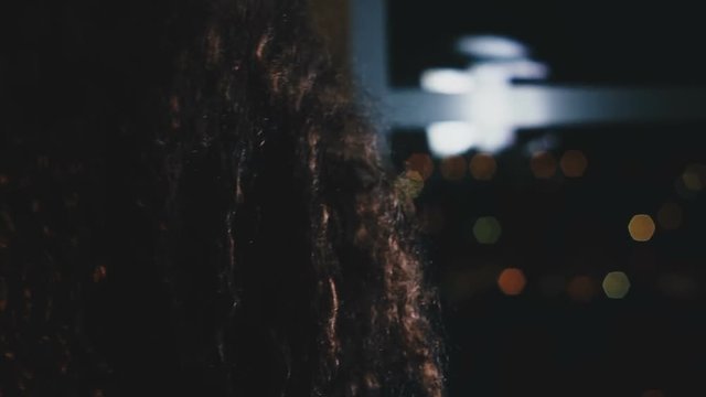 Girl shakes her long curly hair