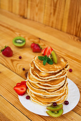 Delicious pancakes on wooden background