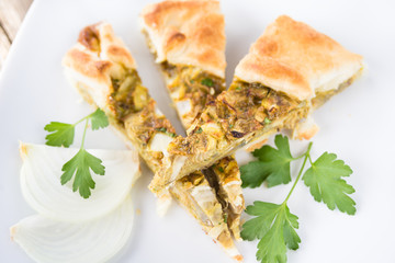 Salty pie with egg, artichoke and onion