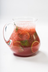 Homemade strawberry lemonade in a glass jug