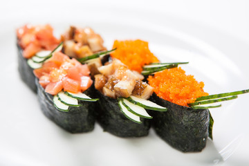 A plate with different kinds of sushi and rolls