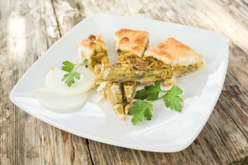 Salty pie with egg, artichoke and onion