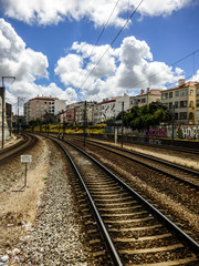 Train tracks in Queluz-Belas station, Lisbon, Portugal. Sign says: Forbidden to walk through the tracks.