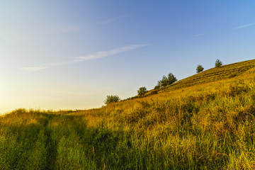 Naklejka premium Sunset over a hill to the country in Romania