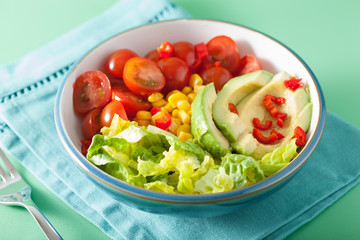 healthy vegan avocado salad with tomatoes and sweetcorn