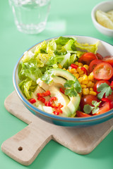 healthy vegan avocado salad with tomatoes and sweetcorn