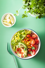 healthy vegan avocado salad with tomatoes and sweetcorn