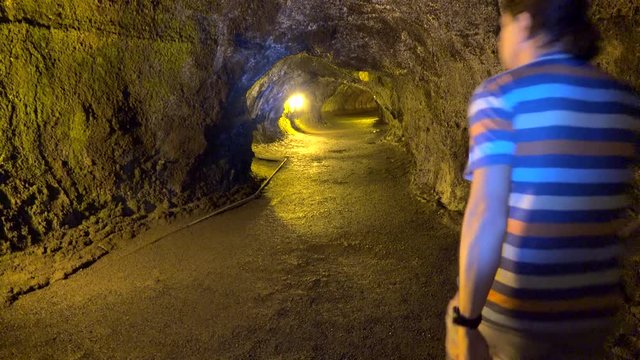 Tourist In The Thurston Lava Tube (Nahuku). Volcanoes NP, Big Island, Hawaii, USA