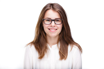 Obraz premium Beautiful young girl in glasses with a black rim a white shirt on an isolated background. Business concept