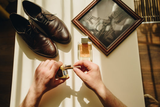 Man collection. Cigarettes, cologne, shoes on white table. Prewedding bisness time.