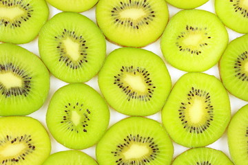 slices of fresh green kiwi fruits food background texture