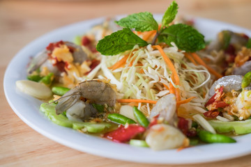 Raw shrimp and spicy sauce / Thai food (spicy salad shrimp in fish sauce) on white dish