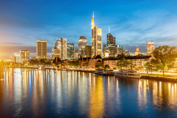 Beautiful panoramic cityscape view with illuminated skyscrapers during the twilight in Frankfurt, Germany