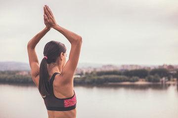 Sporty woman meditating outdoor.