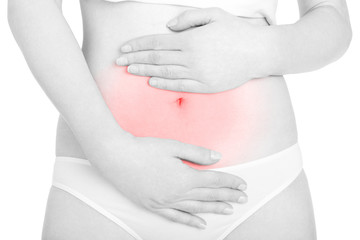 Young woman with hands on belly for abdominal pain isolated on white, clipping path