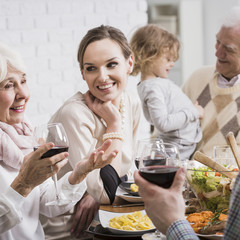 Grandparents and young couple during dinner