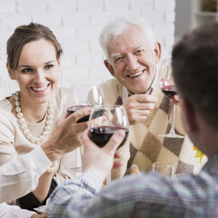 Happy mature and young pairs toasting anniversary