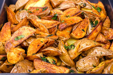 Potatoes cut into pieces with spices. Baked potatoes. Potatoes by the peasants.