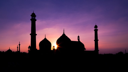 Sun setting behind a mosque