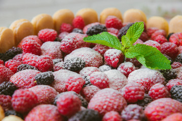 The summer biscuit naked bargaining with cream of mascarpone and fresh berries on a wooden background.