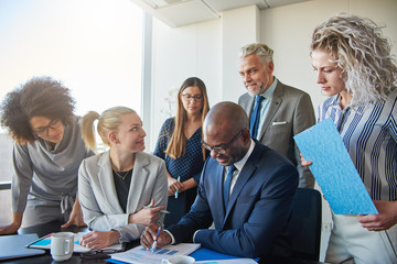 Focused businesspeople working together at a table in an office