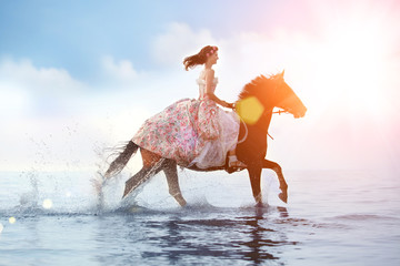 Obraz na płótnie Canvas Image of a woman on a horse by the sea