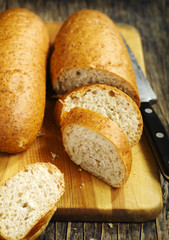 Sliced multigrain bread on a  cooking board.