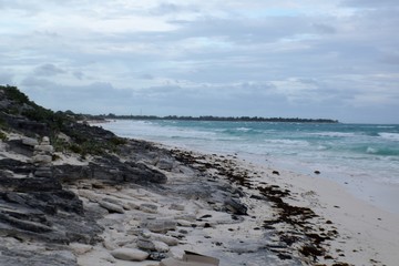 Fototapeta na wymiar Rocky coast at a white sand beach, Cayo Largo, Cuba