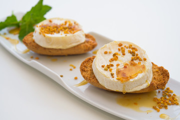  Goat cheese with mint on white plate, macro, isolated,white background