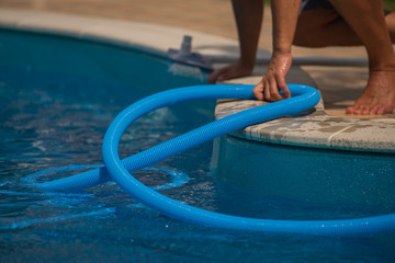 Man cleaning the swimming poolr, closeup