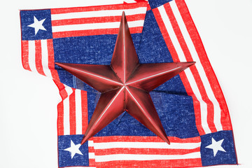 rustic metal star on the US flag bandanna against white background.  