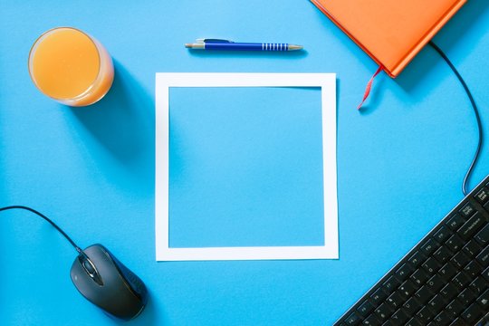 Top View Blue Desk Table. Office Tools On Colored Background. Flat Lay Of Workspace