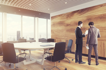 Black round conference room table, men