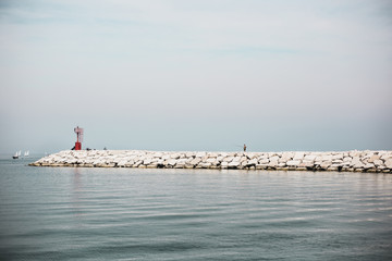 Fisherman in the sea with fishing rod