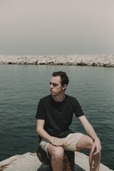 Fototapeta premium Handsome man sitting posing in the sea