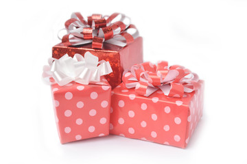 Fototapeta premium Red gift box and ribbon bow on white background. Concept for Valentine day, Christmas present and New Year.