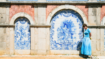 tourist near outside wall of Estoi Palace