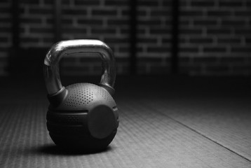 Kettlebell weights in a workout gym in black and white