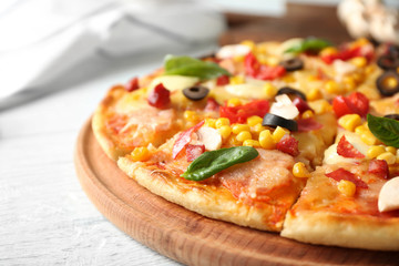 Plate with tasty pizza on wooden table, close up view
