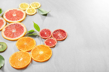 Citrus slices on light background