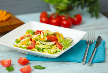 Plate with tasty salad on table