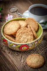 Stack of freshly baked oat biscuits in a bowl.