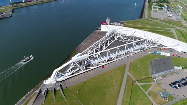 Aerial flying over Rotterdam Hoek van Holland Maeslantkering storm surge barrier part of the Delta Works and one of largest moving structures on Earth also showing ship passing the Maeslant Barrier 4k