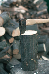 Felling firewood with an ax with a blurred background.