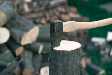 Felling firewood with an ax with a blurred background.